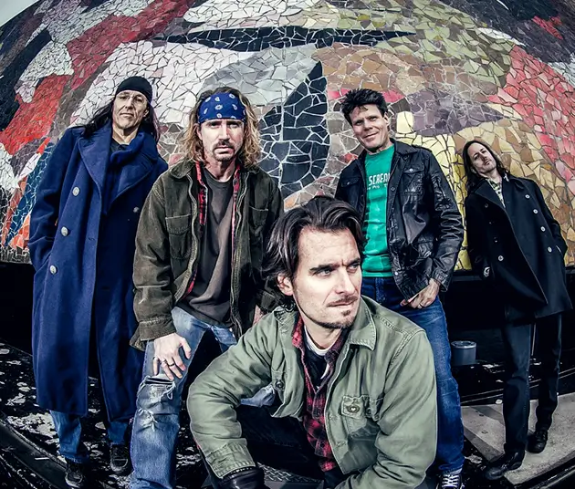 An image of the Washed in Black band members in front of a colorful wall.