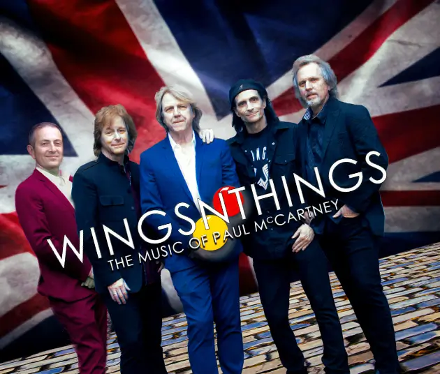 Five members of the Wings N Things in front of a Great Britain flag.