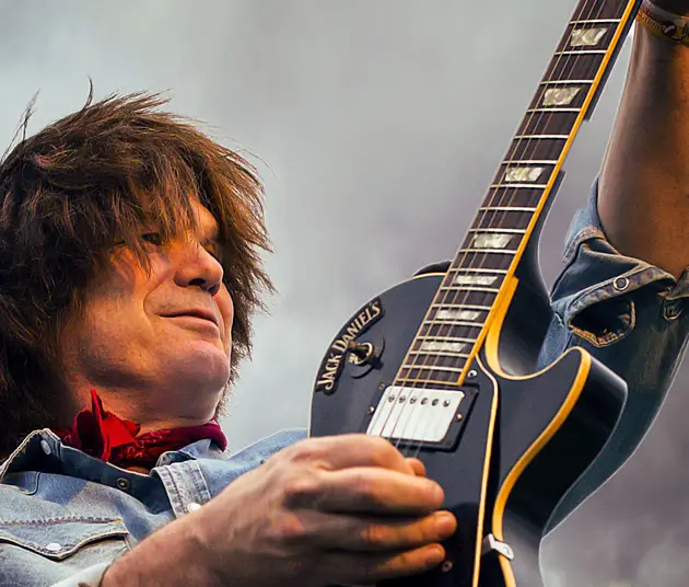 Randy Linder playing a black guitar.